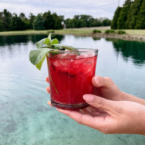 Beautiful Blackberry Mojito cocktail at a beach