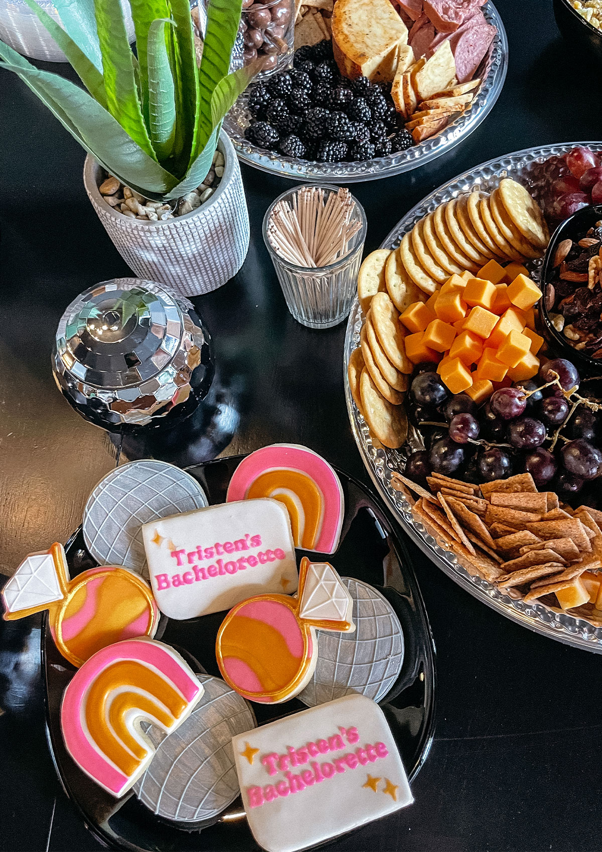 Appetizing cheese plate and colorful sugar cookies