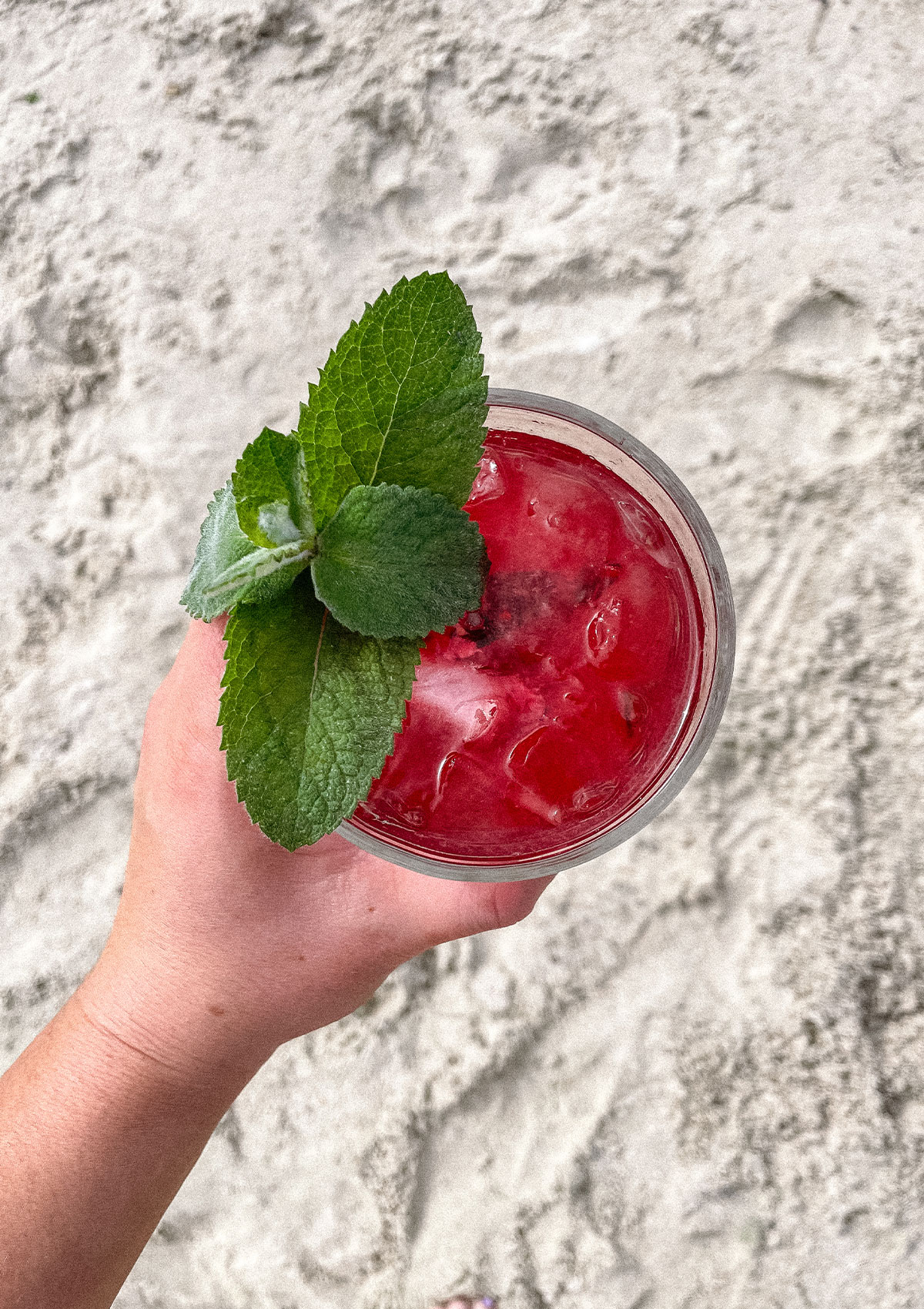 Blackberry Mojito with a fresh sprig of mint at the beach