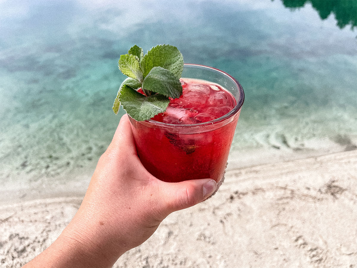 Beautiful Blackberry Mojito with a fresh sprig of mint at the beach