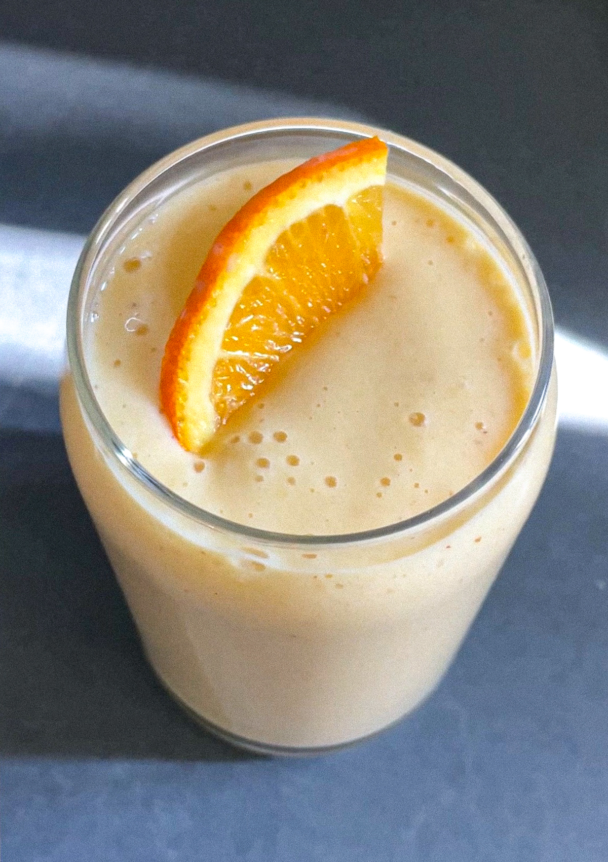 Delicious Orange Dream Smoothie in a glass garnished with an orange slice