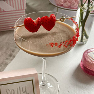 Baileys Chocolate Espresso Martini garnished with red sugar sprinkles and heart-shaped strawberries