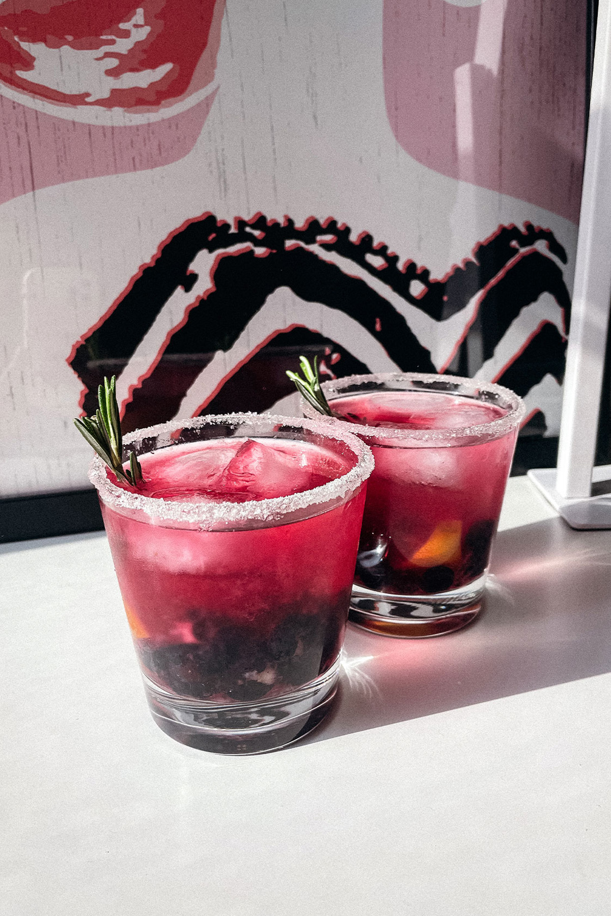 Gorgeous Blueberry Lemon Smash cocktails in sugar-rimmed glasses