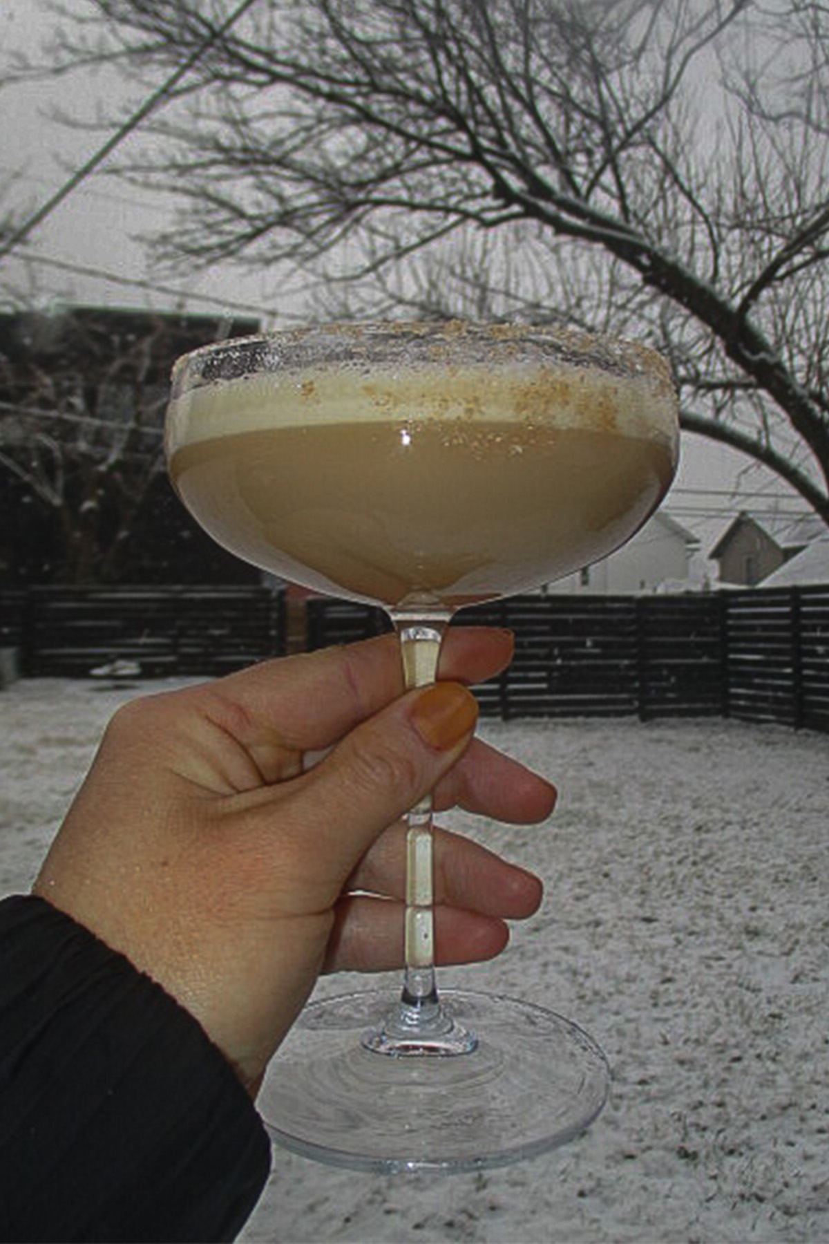 Dirty Chai Martini with snow falling around it