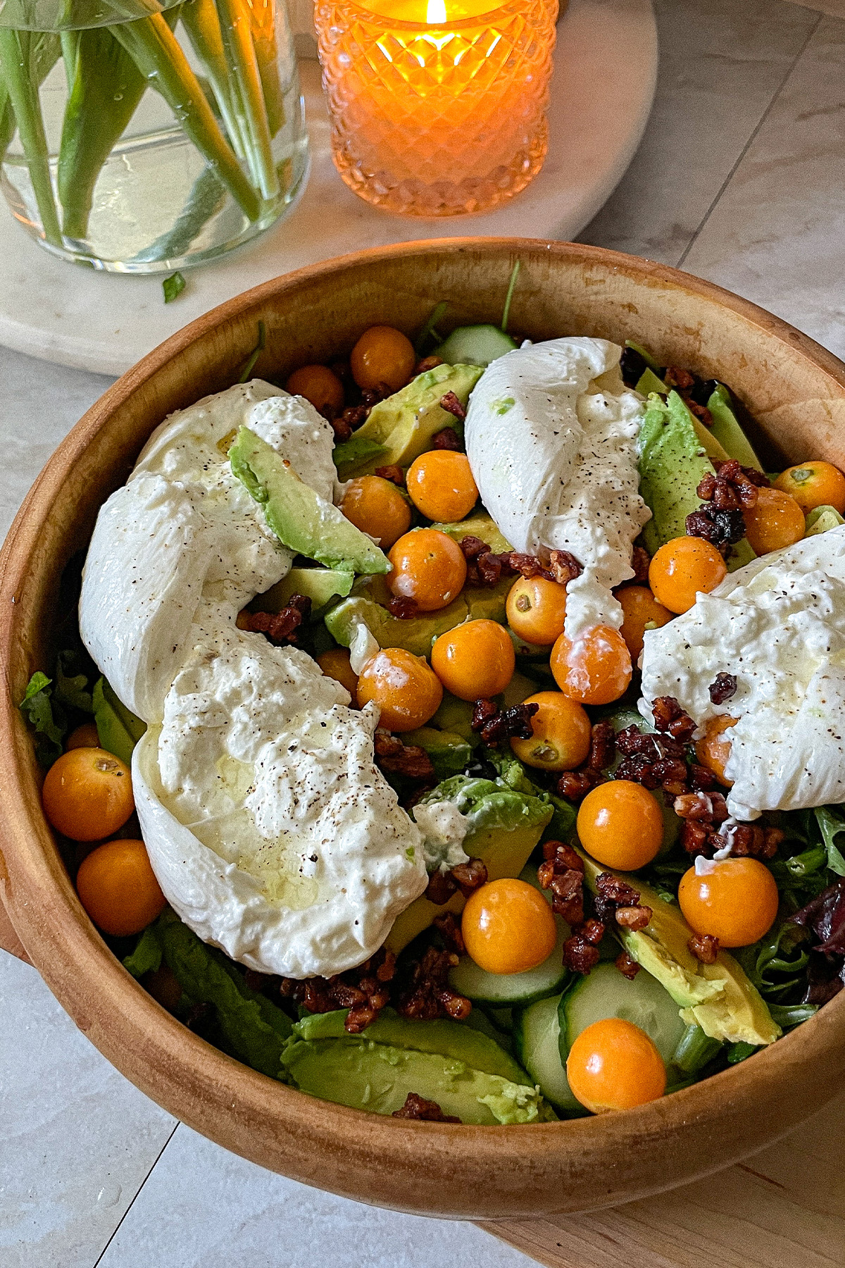 Gooseberry Burrata salad served in a decorative wooden bowl