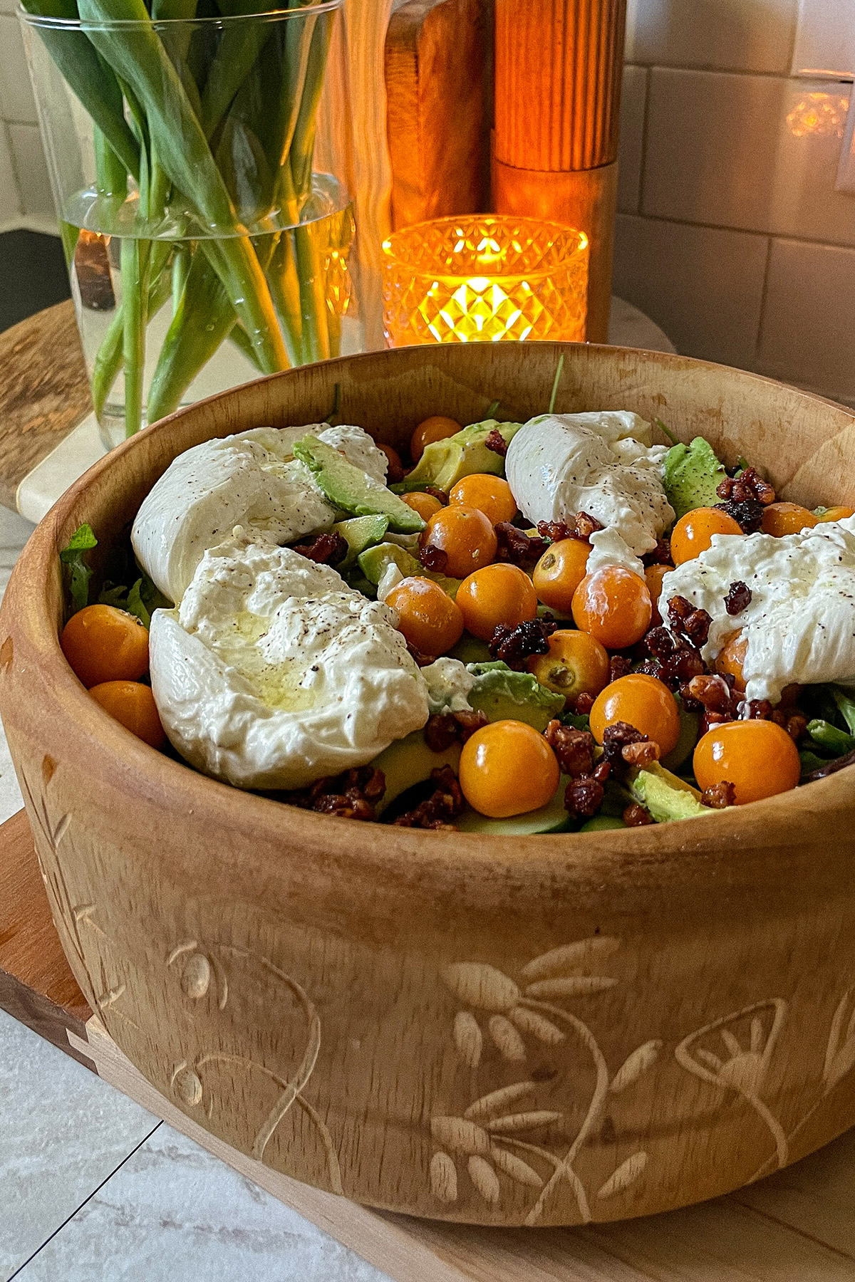 Gooseberry Burrata salad served in a decorative wooden bowl