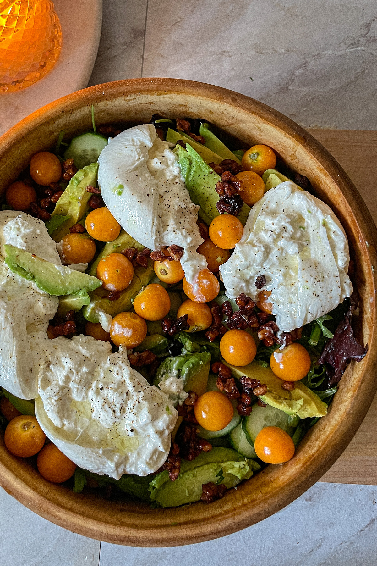 Gooseberry Burrata salad served in a decorative wooden bowl