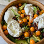 Gooseberry Burrata salad served in a decorative wooden bowl