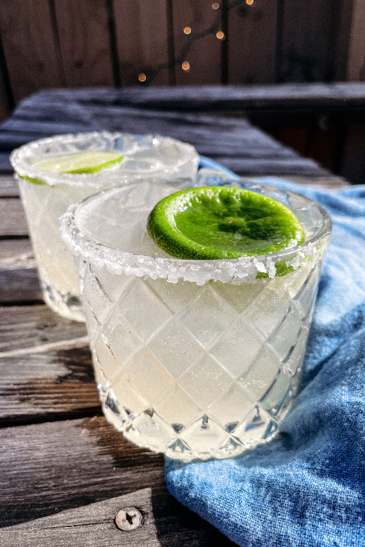 Skinny Margaritas served in salt-rimmed glasses topped with a wheel of lime