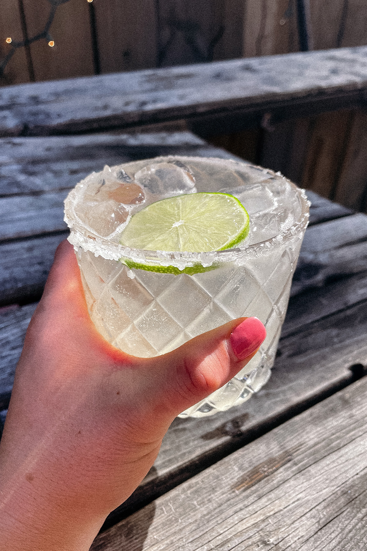 Skinny Margarita served in a salt-rimmed glass topped with a wheel of lime