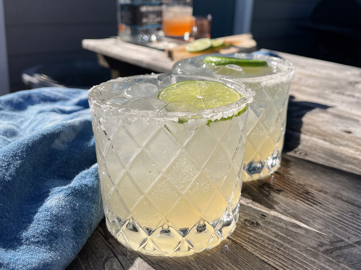 Skinny Margaritas served in salt-rimmed glasses topped with a wheel of lime