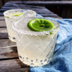 Skinny Margaritas served in salt-rimmed glasses topped with a wheel of lime