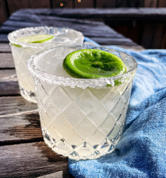 Skinny Margaritas served in salt-rimmed glasses topped with a wheel of lime