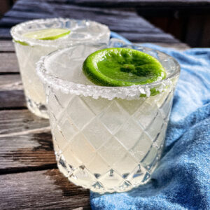 Skinny Margaritas served in salt-rimmed glasses topped with a wheel of lime