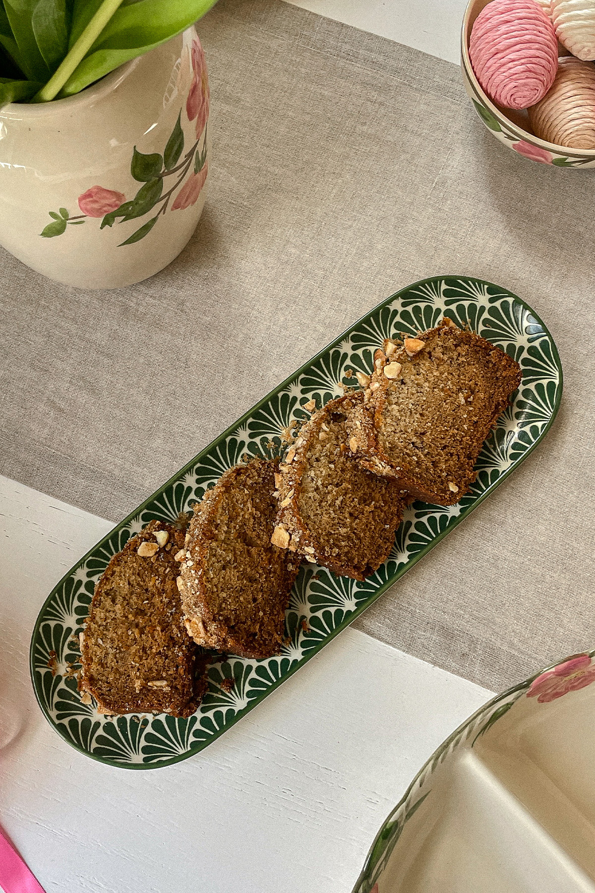 Fresh slices of homemade Brown Sugar-Crusted Banana Bread laid on a serving plate.