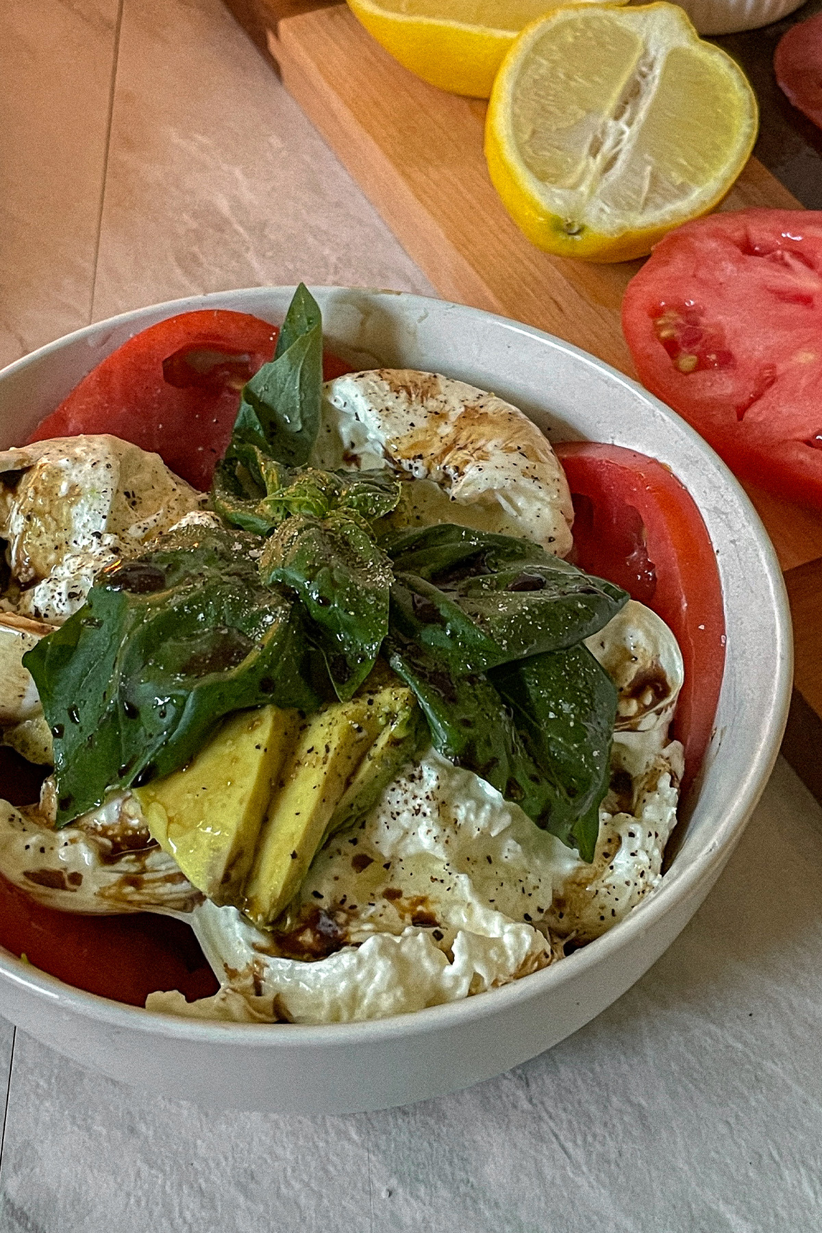 Beautiful Burrata Caprese Salad layered in a bowl