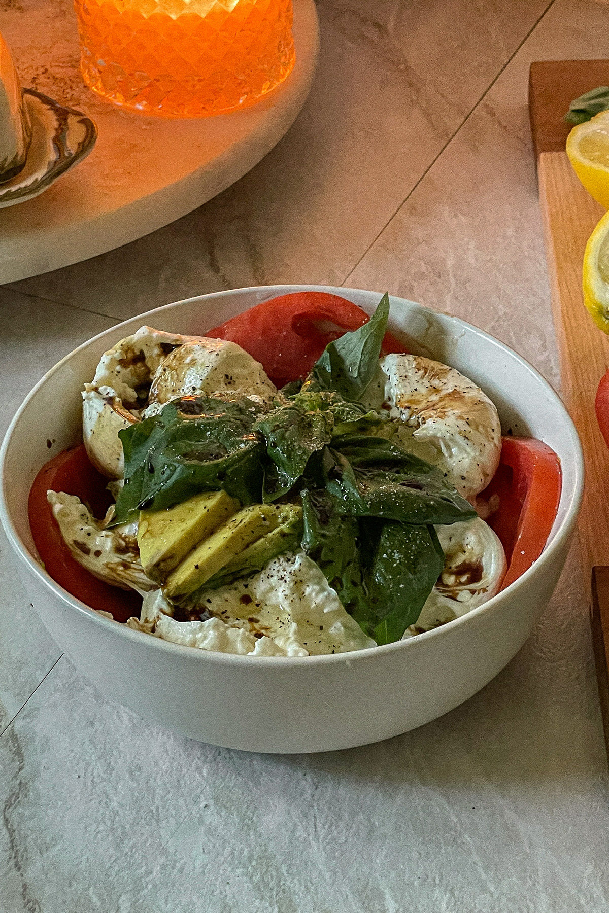 Beautiful Burrata Caprese Salad layered in a bowl