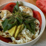 Beautiful Burrata Caprese Salad layered in a bowl