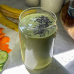 Refreshing tropical green smoothie in a glass topped with chia seeds