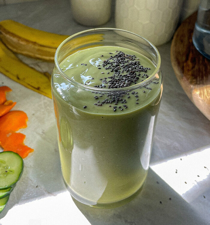 Refreshing tropical green smoothie in a glass topped with chia seeds