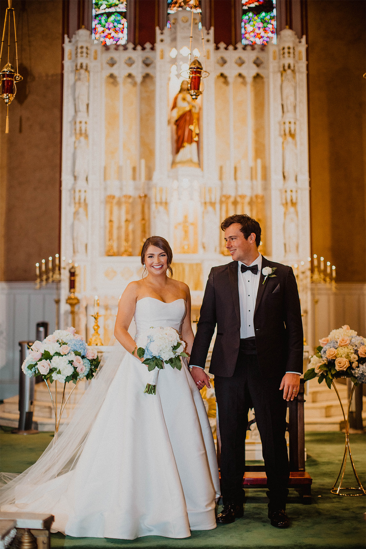 Bride and groom smiling at the altar