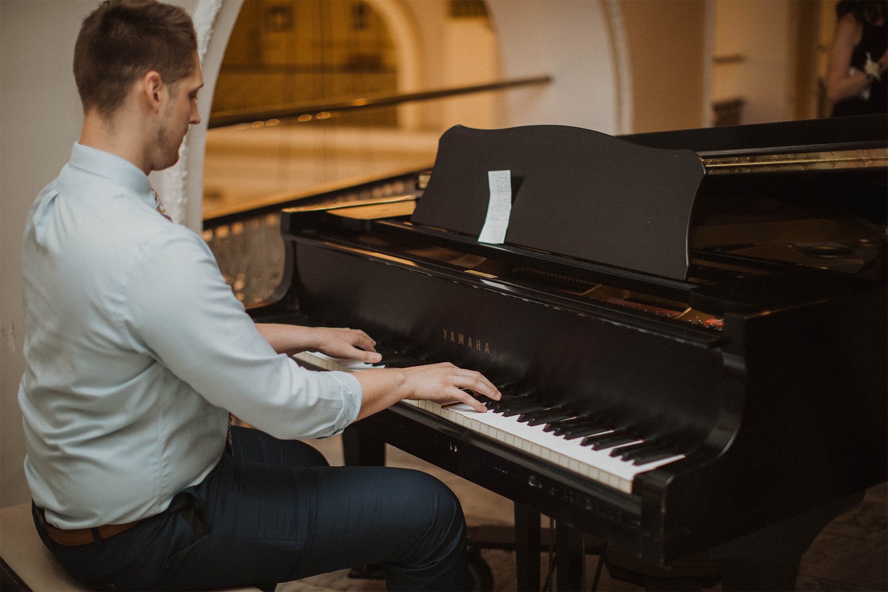 Man playing the piano at wedding cocktail hour