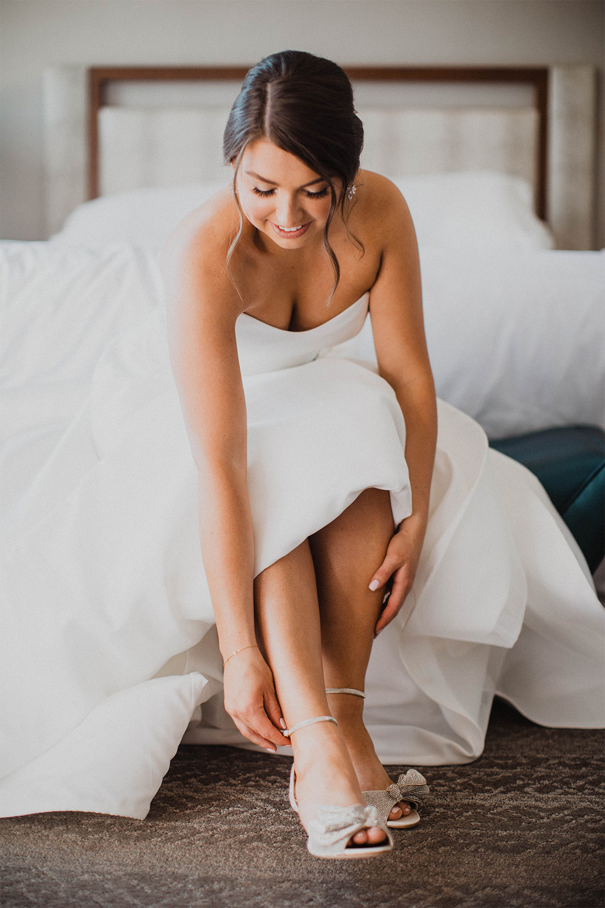 Bride clasping her wedding shoes