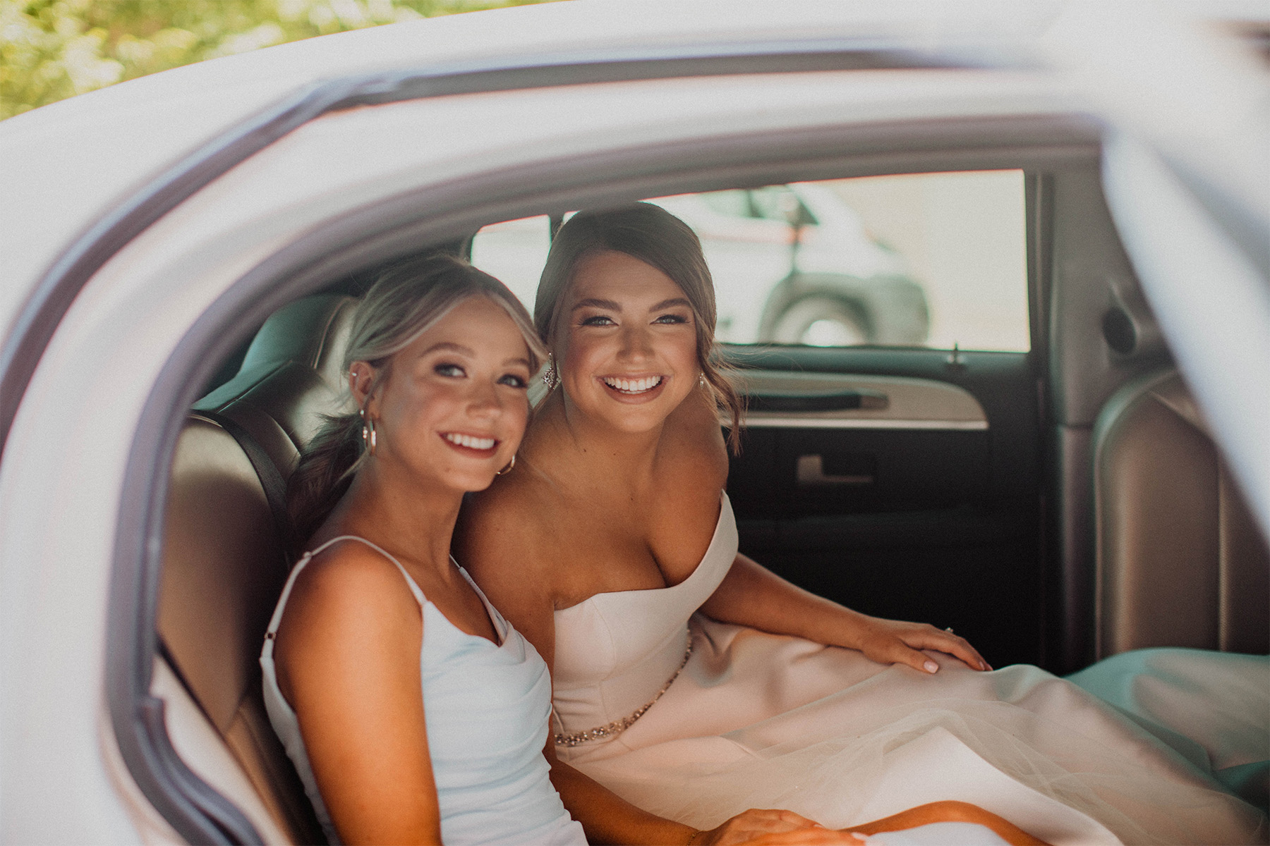 Bride and maid of honor in a limousine