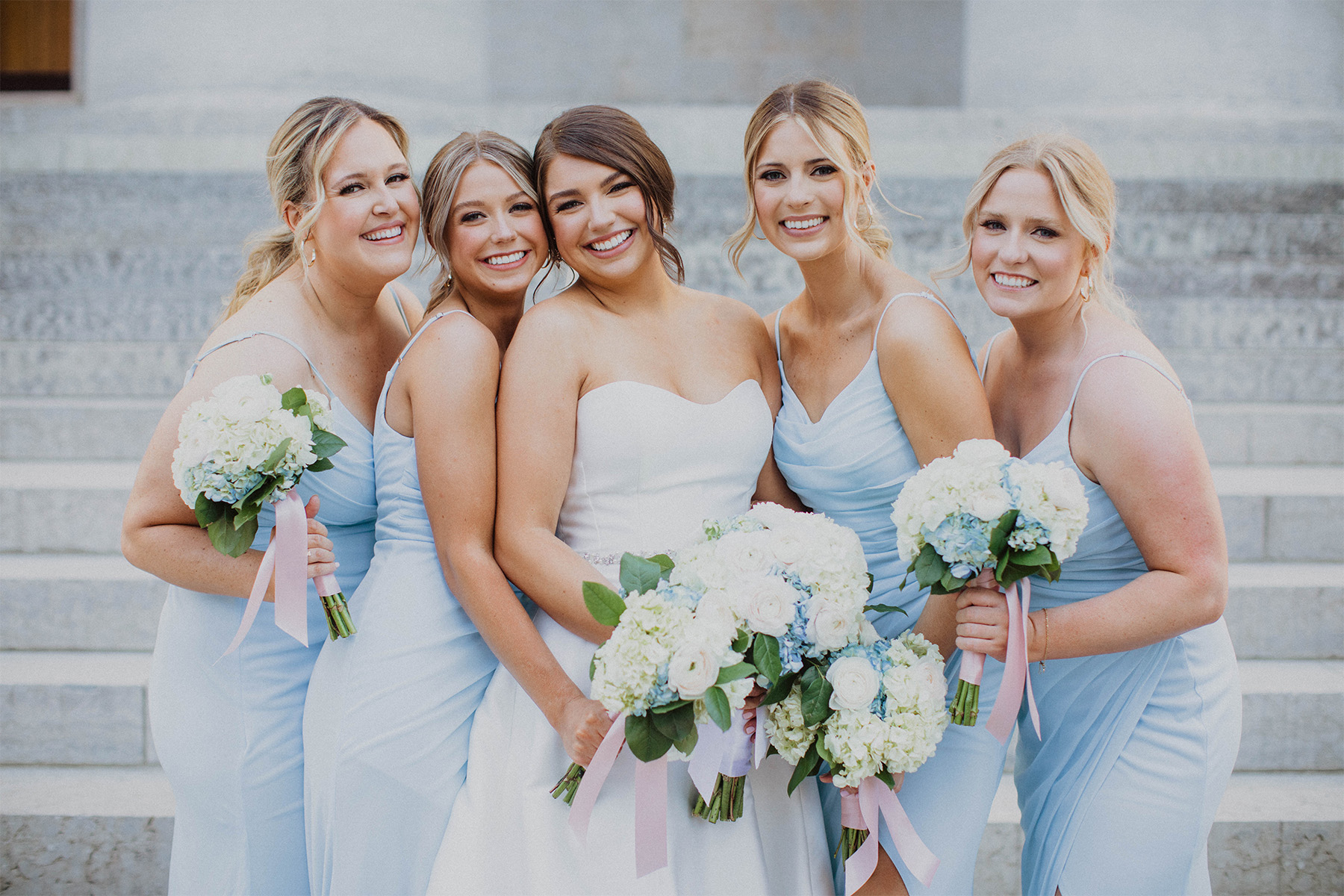 Bride and bridesmaids wearing light blue dresses