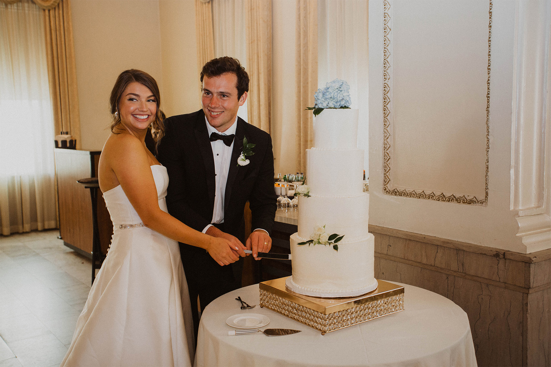 Bride and groom cutting their wedding cake