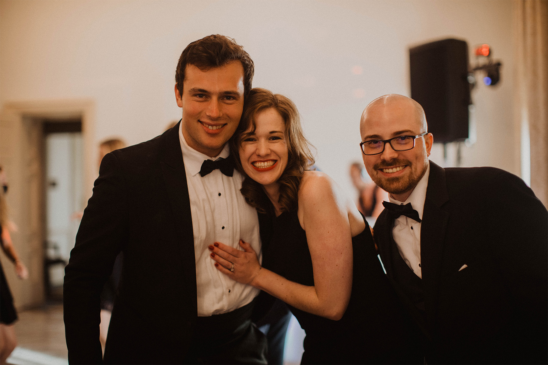 Groom posing with family at wedding reception