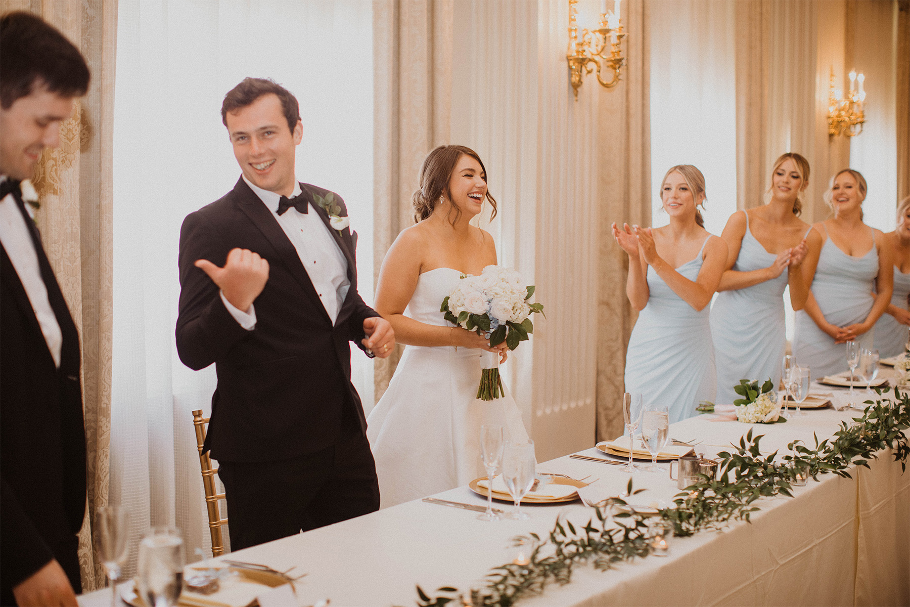 Bride and groom celebrating at the wedding party table