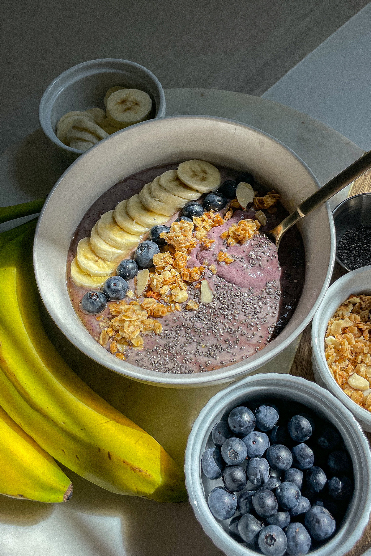 Blueberry Smoothie Bowl topped with sliced bananas, blueberries, granola and chia seeds