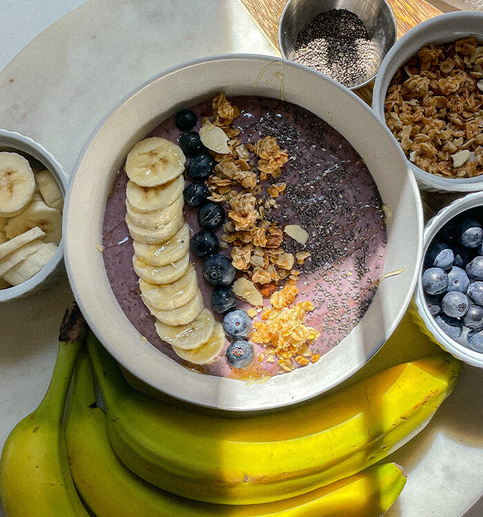 Blueberry Smoothie Bowl topped with sliced bananas, blueberries, granola and chia seeds