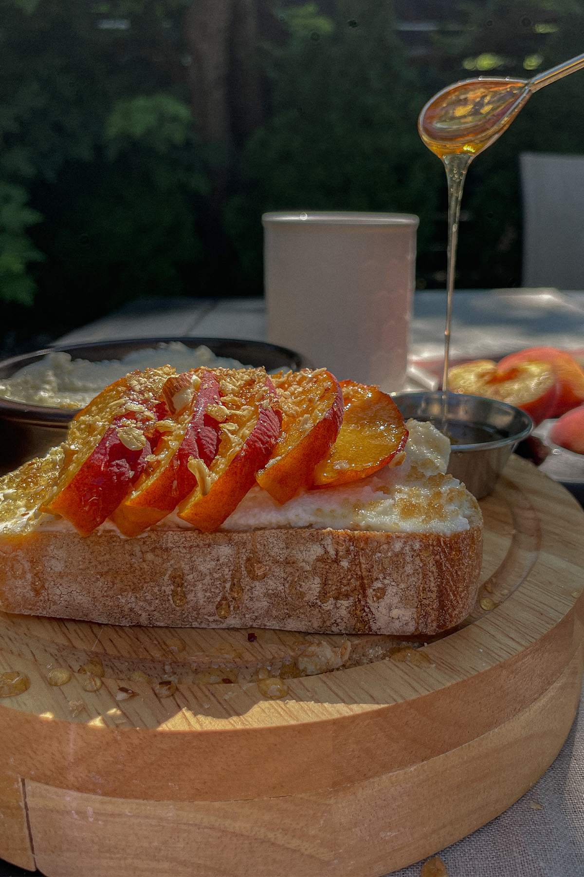 Pouring honey over Peach Ricotta Toast