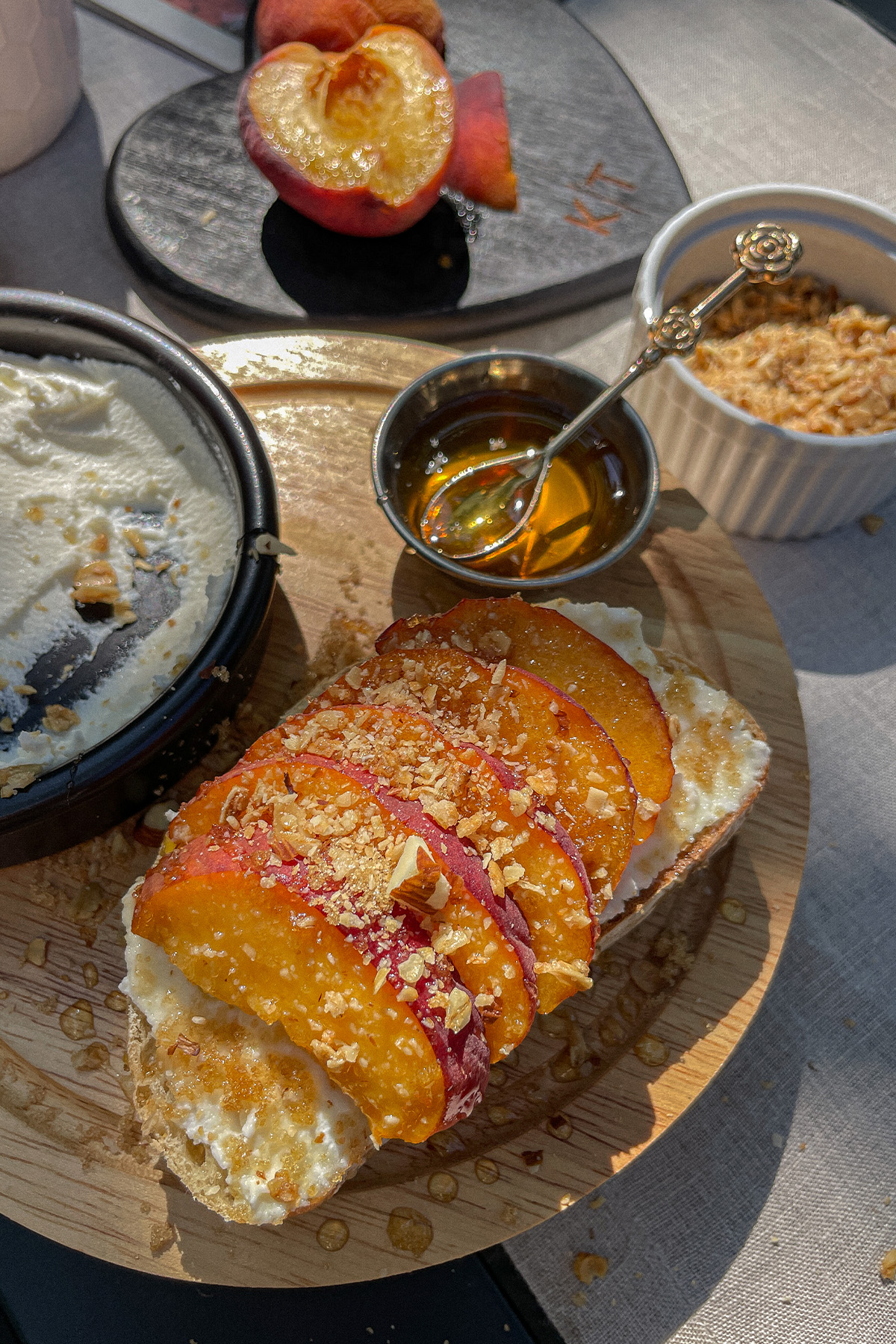 Beautiful slice of Peach Ricotta Toast on a wooden tray