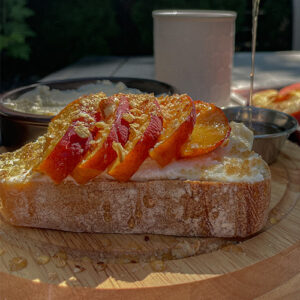 Pouring honey over Peach Ricotta Toast