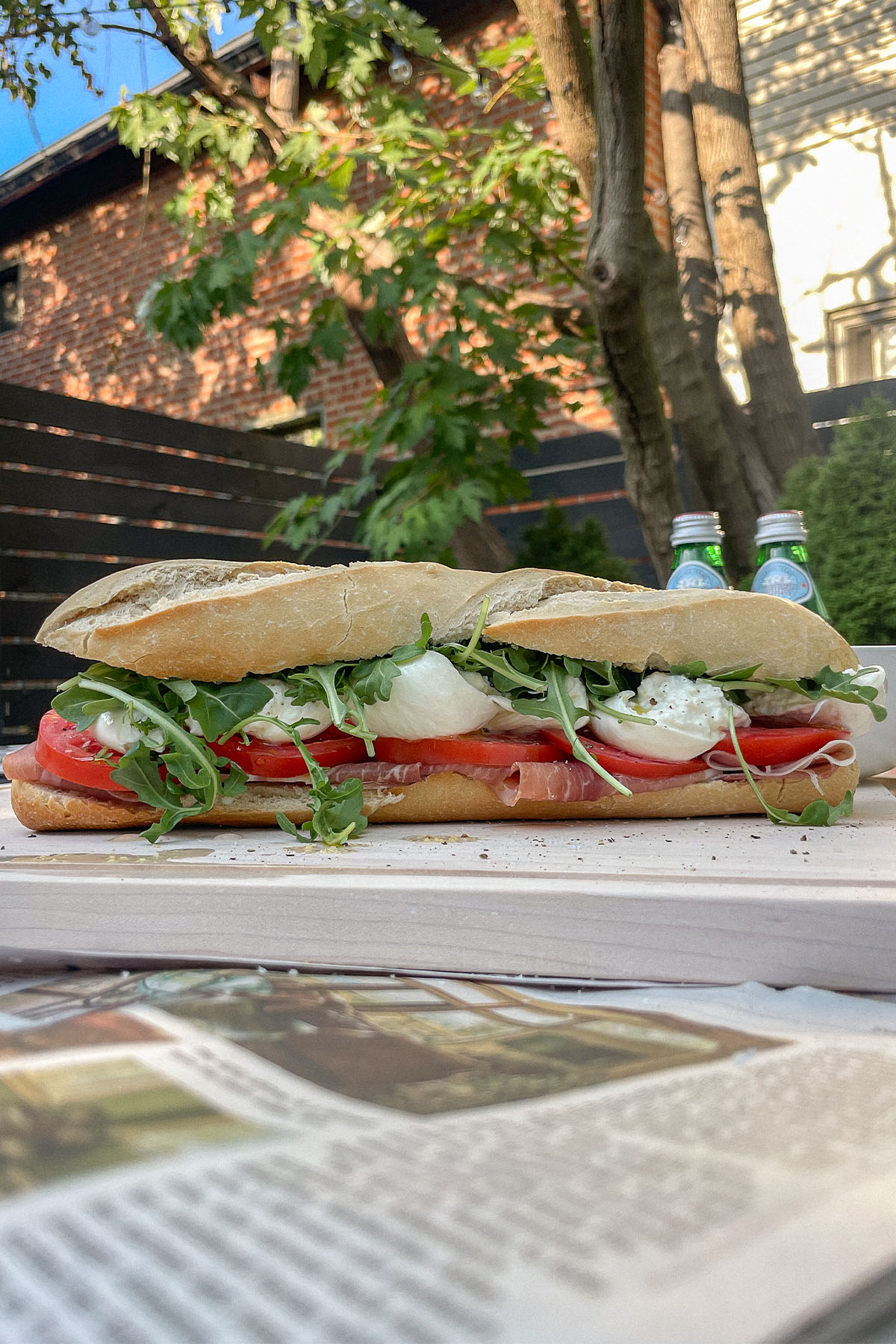 Prosciutto Burrata Baguette Sandwich on a wooden cutting board