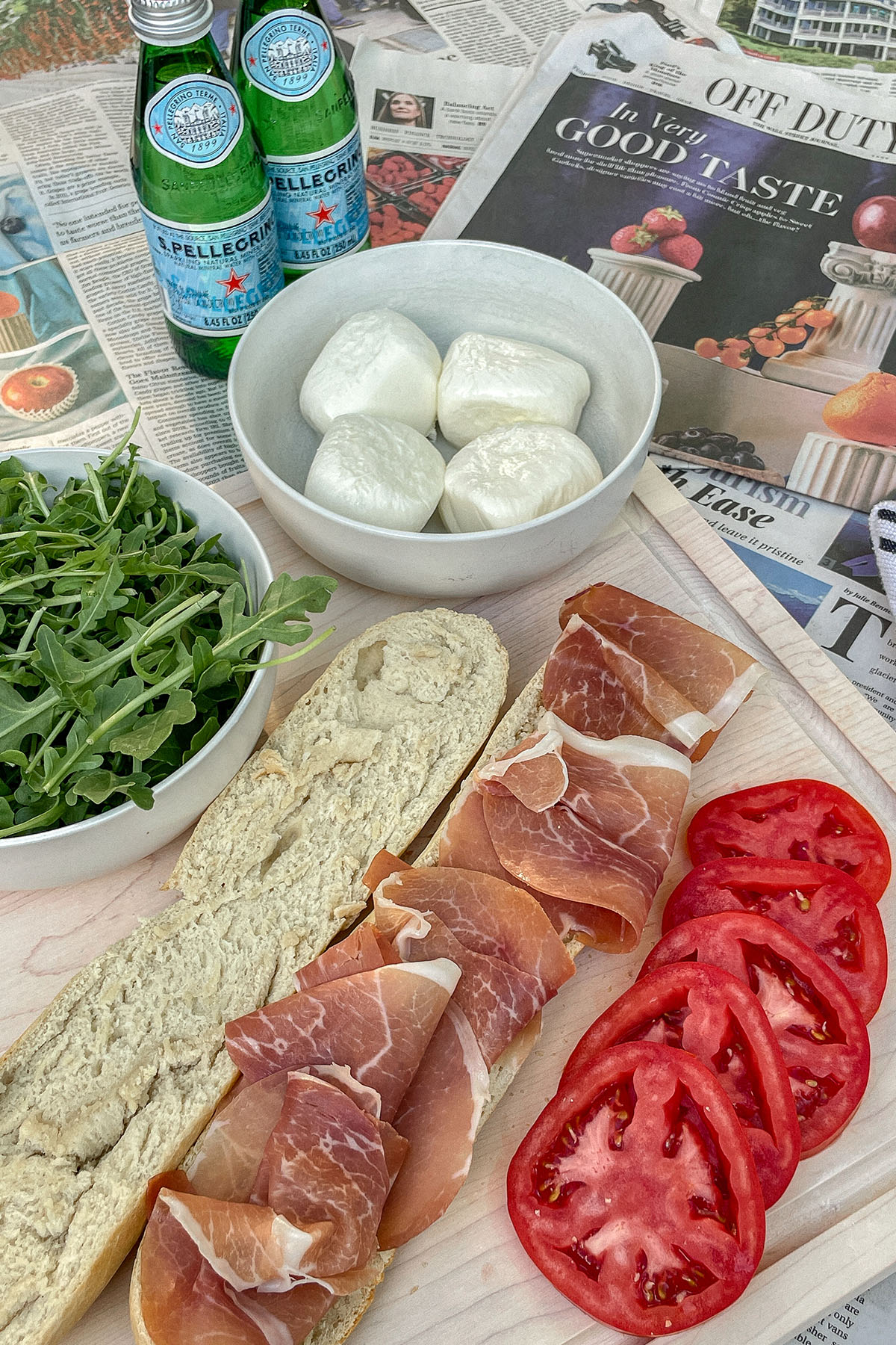 Prosciutto Burrata Baguette Sandwich ingredients on a wooden cutting board