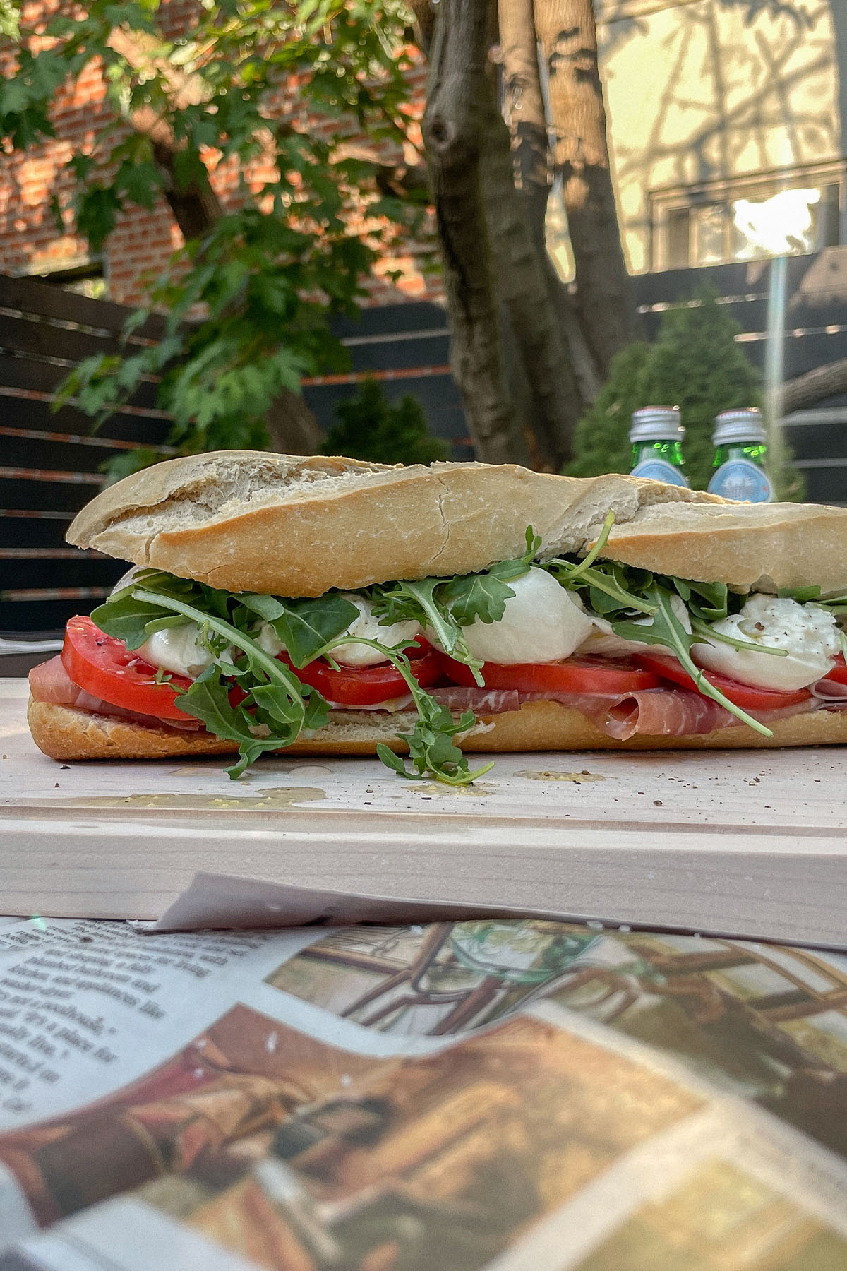 Prosciutto Burrata Baguette Sandwich on a wooden cutting board