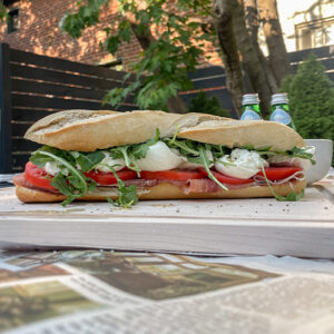 Prosciutto Burrata Baguette Sandwich on a wooden cutting board