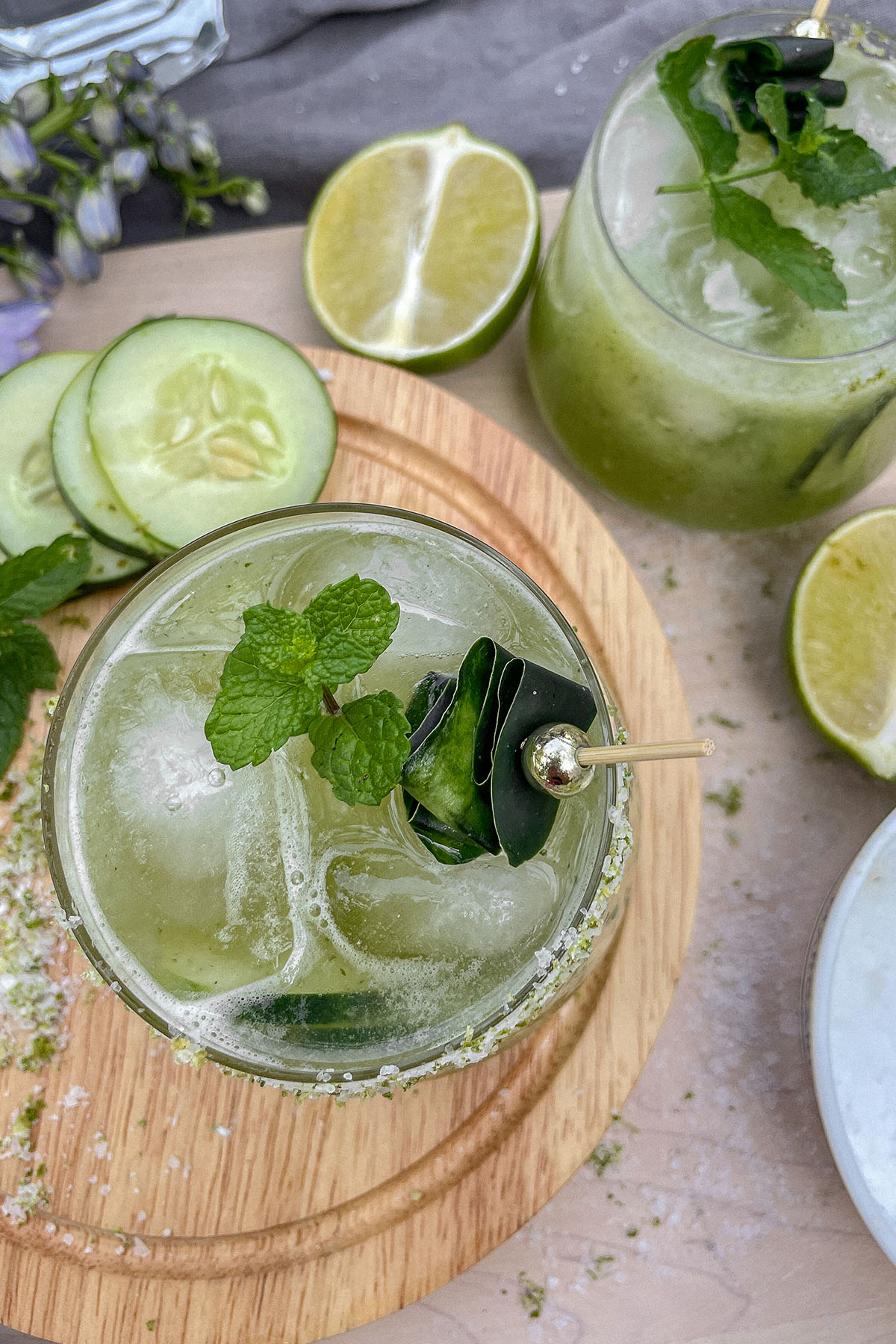 Cucumber Mint Margaritas served in rocks glasses with fresh mint and cucumber garnish