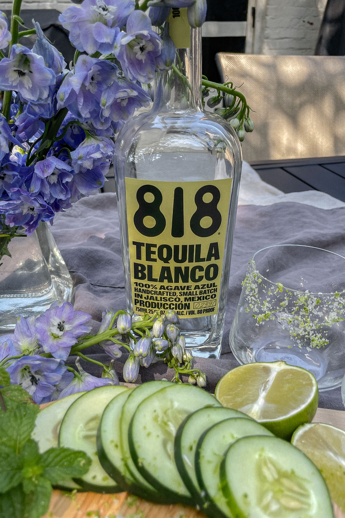 818 Tequila bottle, freshly sliced cucumers and limes