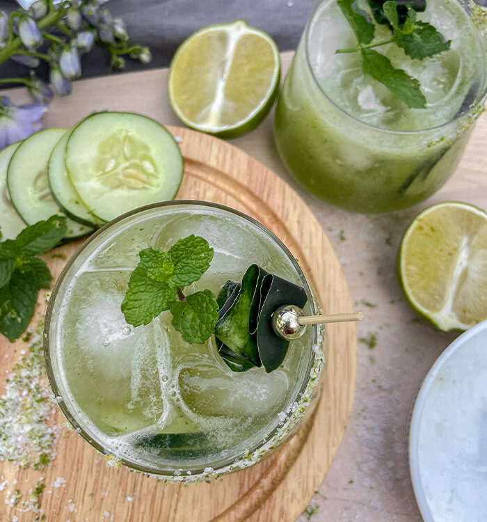 Cucumber Mint Margaritas served in rocks glasses with fresh mint and cucumber garnish