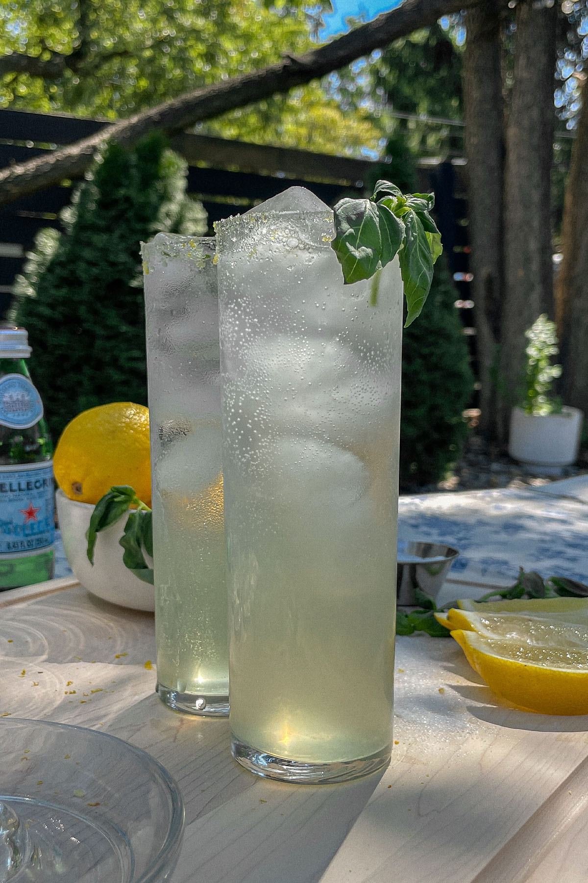 Two Sparkling Basil Lemonade Cocktails served in slim glasses