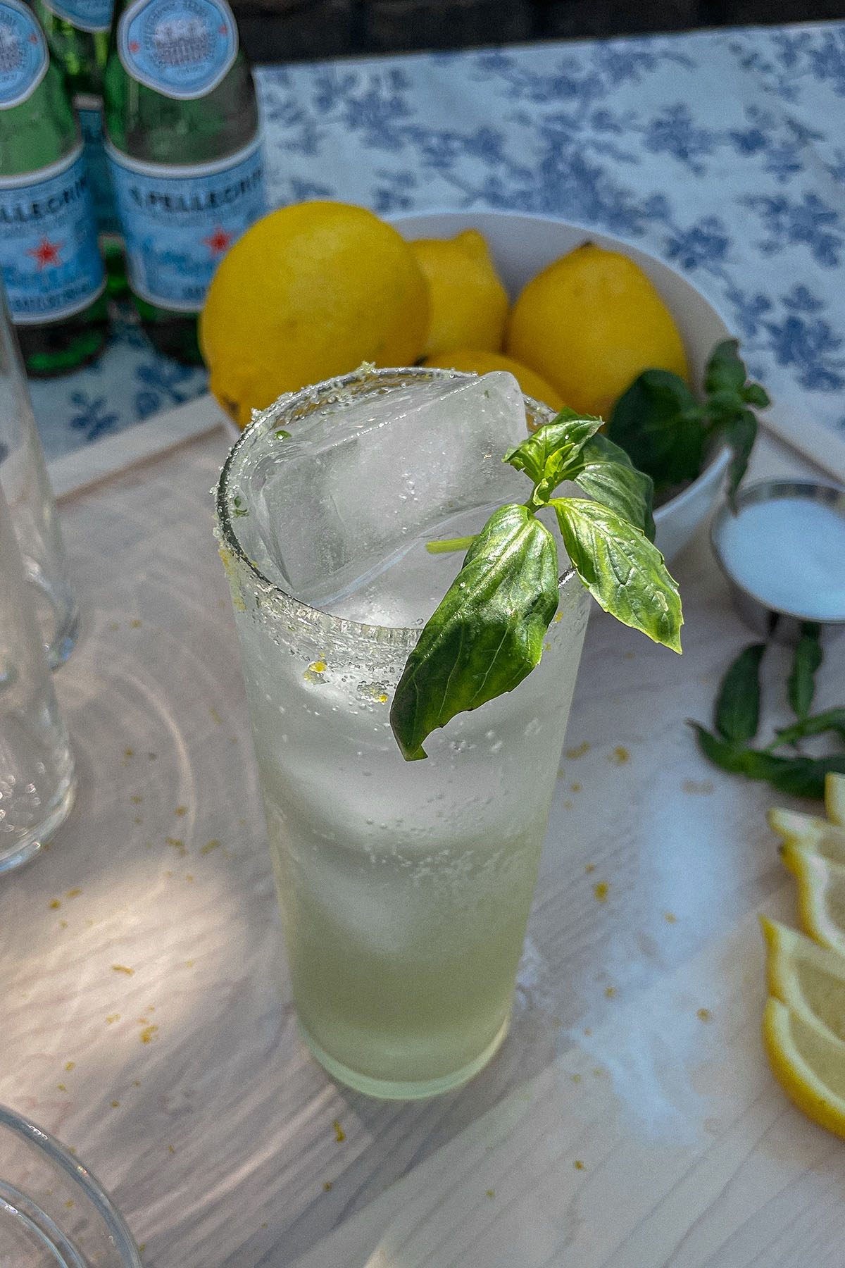 Sparkling Basil Lemonade Cocktail served in a slim glass with fresh basil garnish