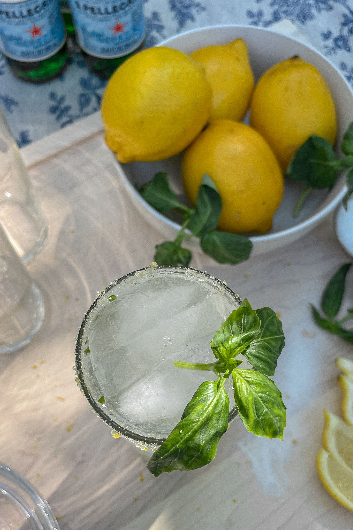 Sparkling Basil Lemonade Cocktail served in a slim glass with fresh basil garnish