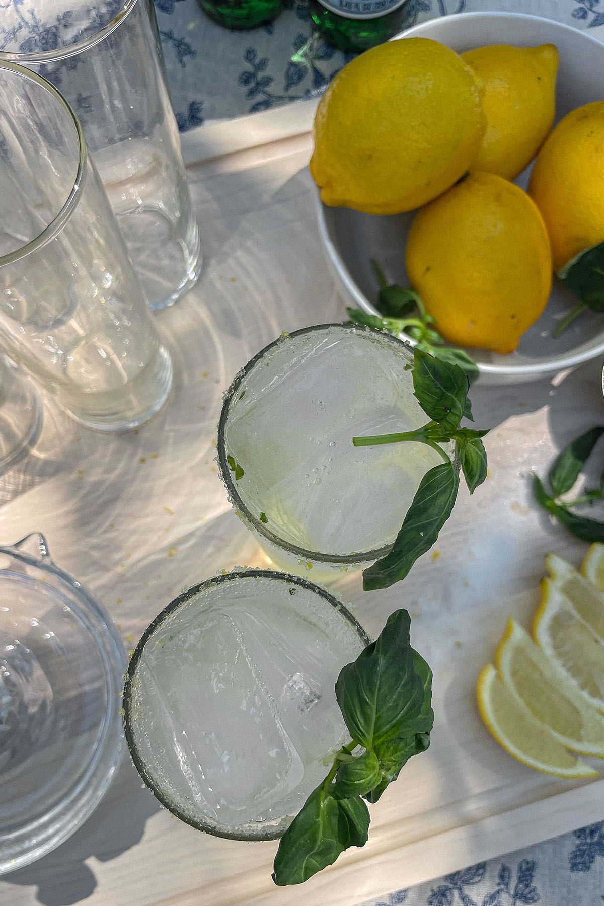 Sparkling Basil Lemonade Cocktails next to a bowl of lemons