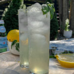 Two Sparkling Basil Lemonade Cocktails served in slim glasses