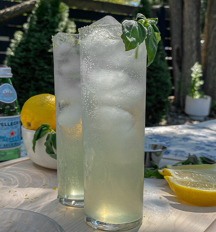 Two Sparkling Basil Lemonade Cocktails served in slim glasses